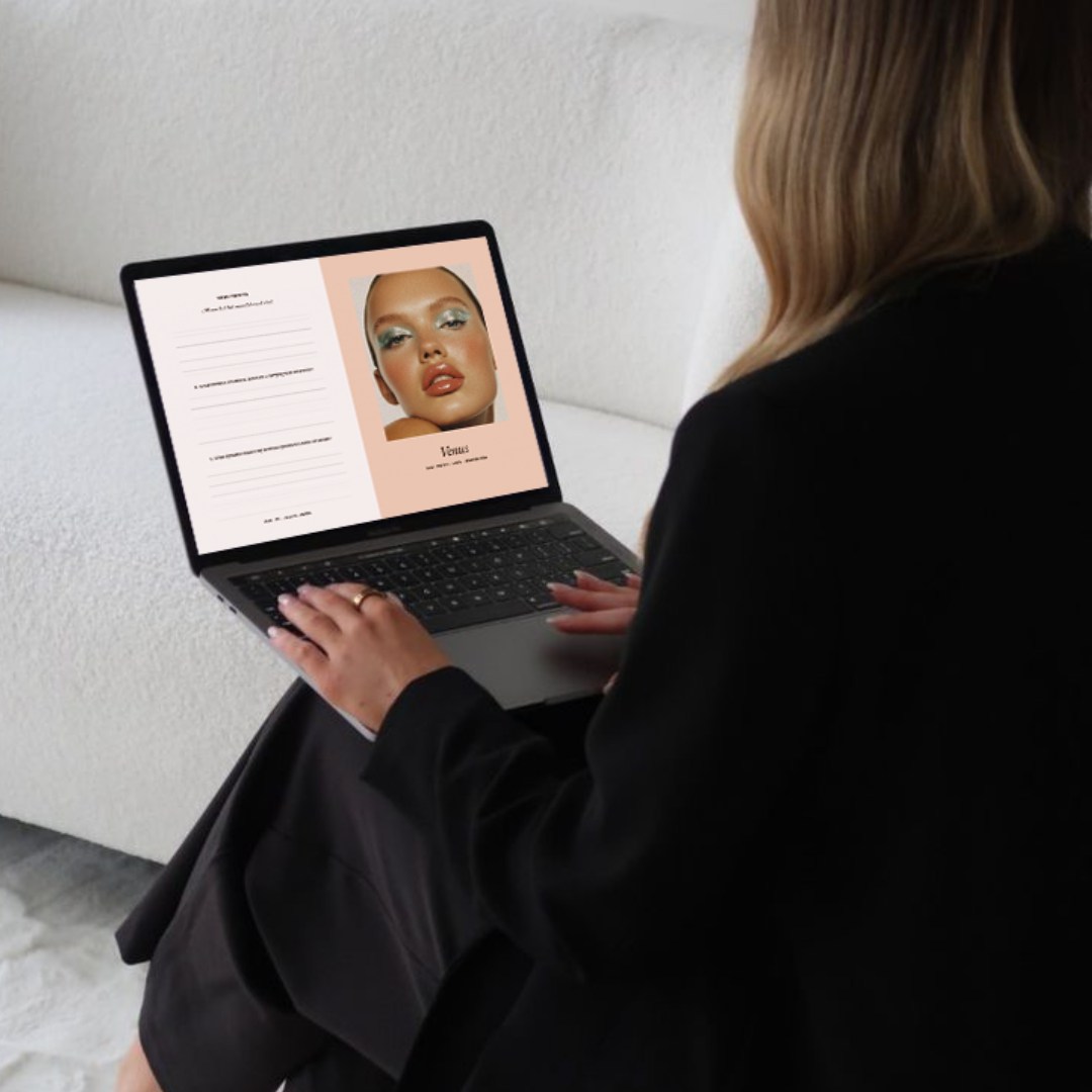 Person using a laptop with a digital journal product display on the screen.